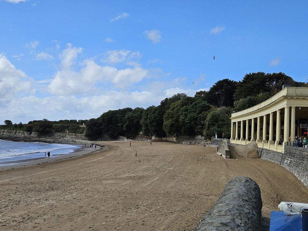 Sand, sea wall and the colonnaded shelter on the seafront at Barry