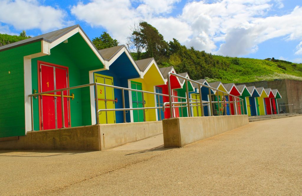 Coloured beach huts above the sand at Whitmore Bay, Barry Island