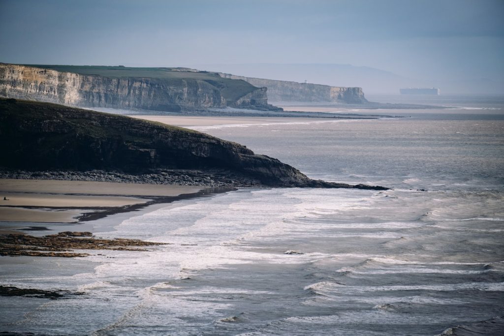 Wide sand and banded cliffs along the Glamorgan Heritage Coast
